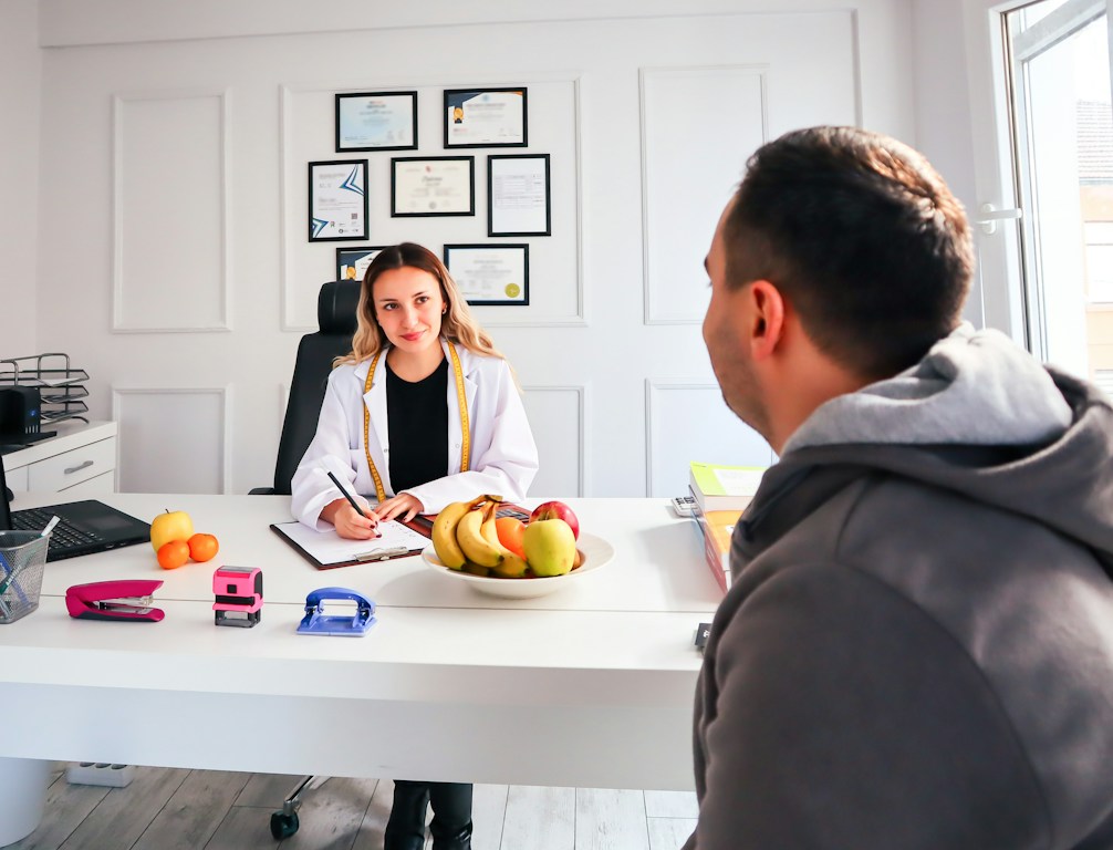 A friendly healthcare professional answering a call in a clean, modern office.