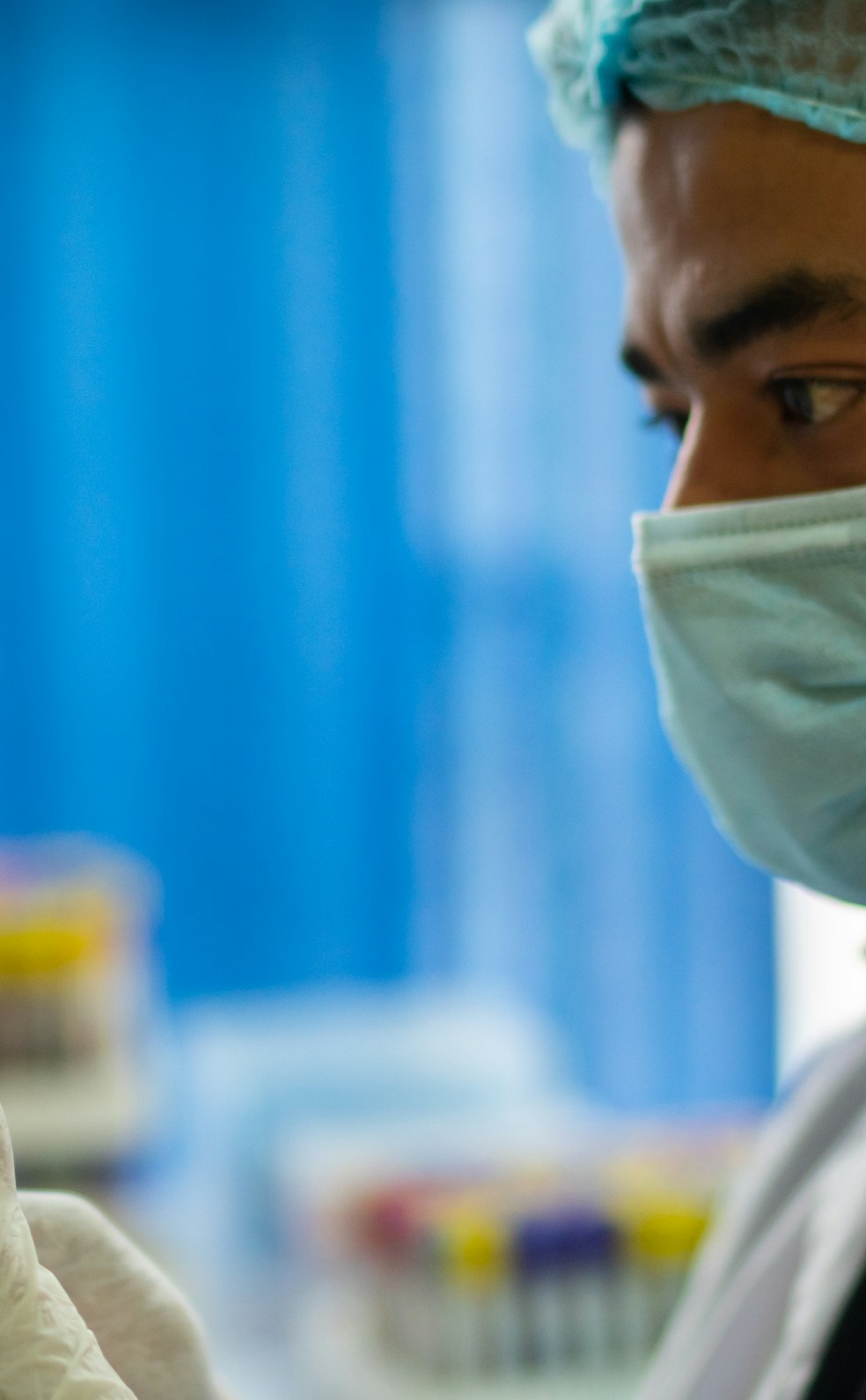 Close-up of a healthcare professional preparing a stem cell therapy vial in a clinical setting.
