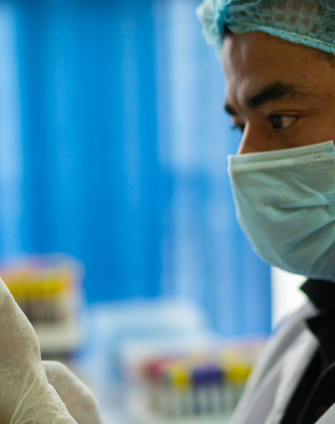 Close-up of a healthcare professional preparing a stem cell therapy vial in a clinical setting.