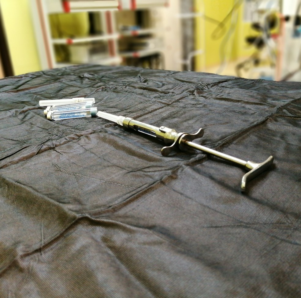 Close-up of a Visco HA injection vial with a syringe against a clean clinical background.