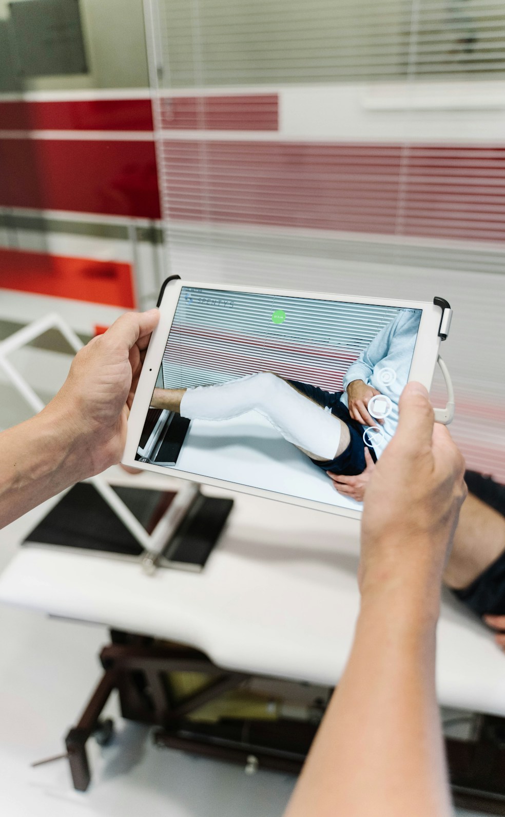 Doctors discussing patient treatment plans with regenerative medicine visuals on a digital screen.