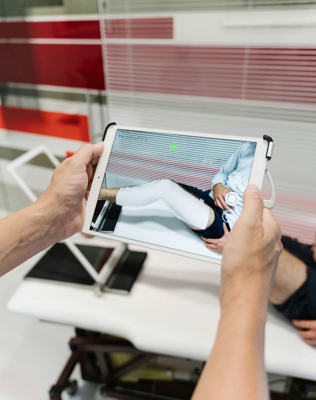 Doctors discussing patient treatment plans with regenerative medicine visuals on a digital screen.