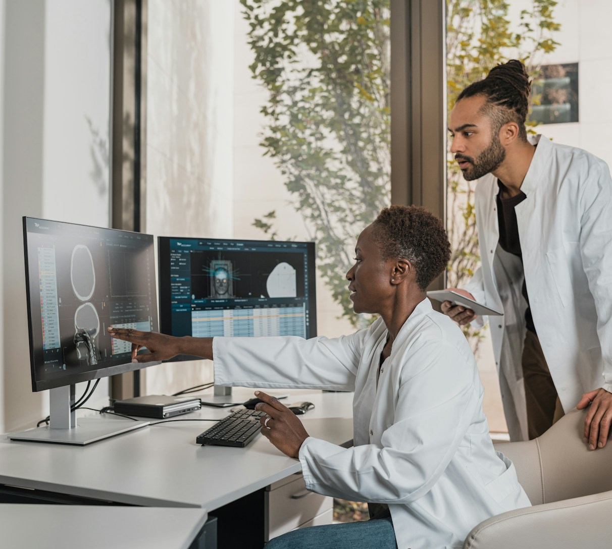 Photo of Sam Ho and Mattie Wong discussing medical products in a modern healthcare office.