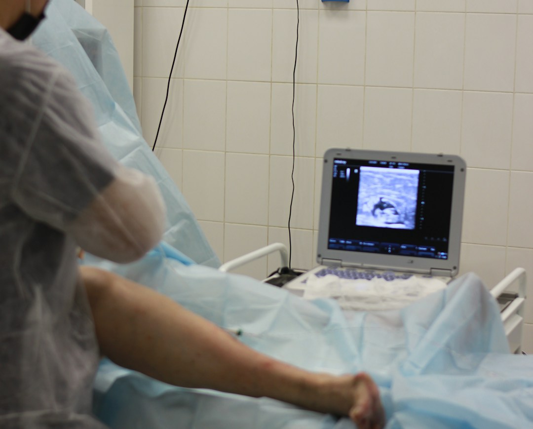 Medical professional administering hyaluronic acid injection to a patient's knee.