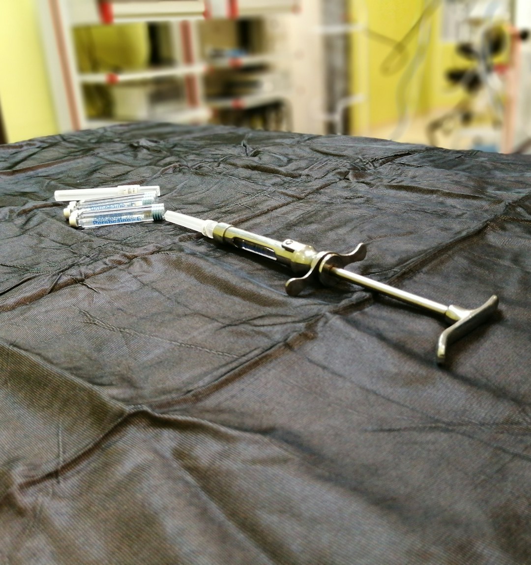Close-up of a Visco HA injection vial with a syringe against a clean clinical background.